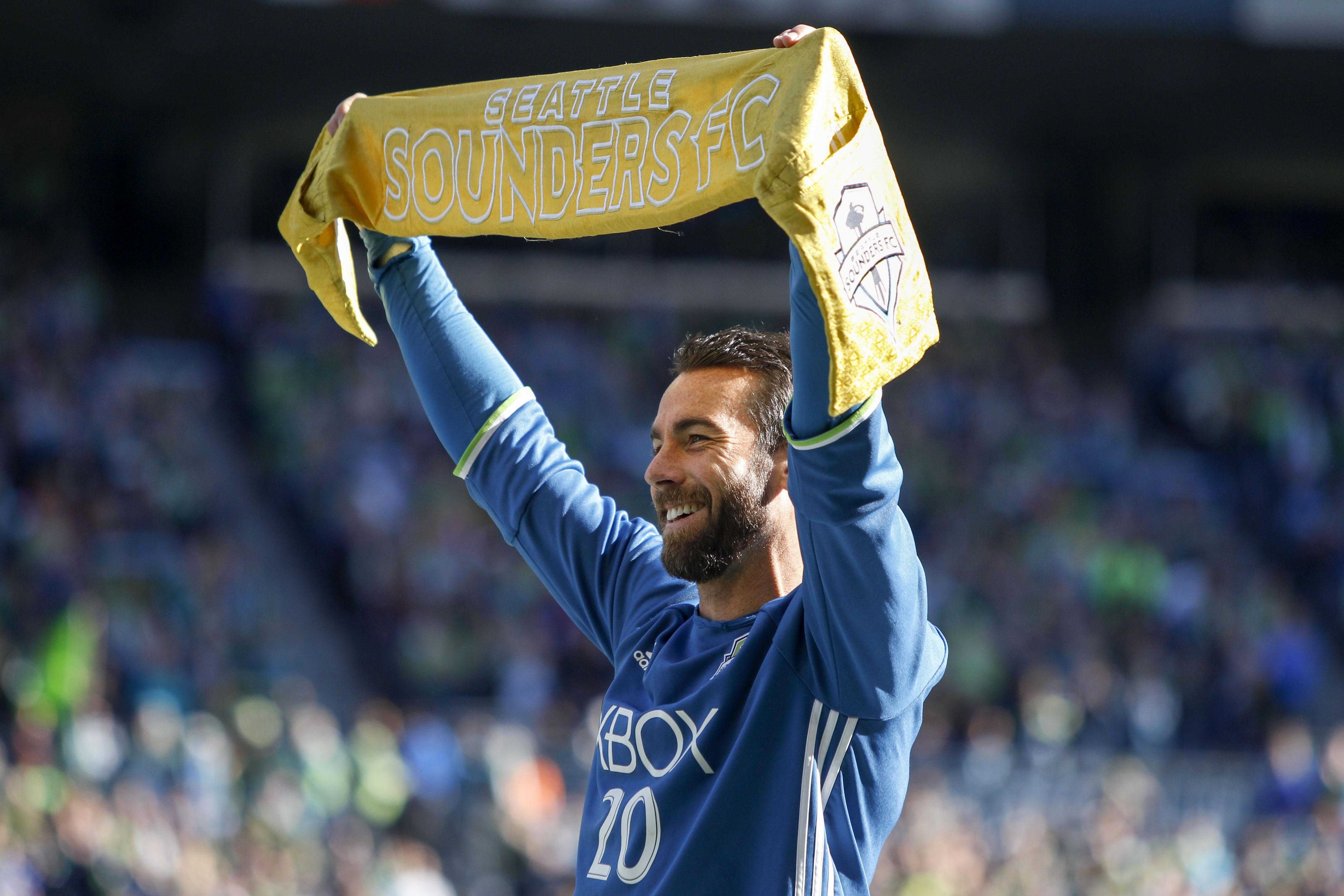 Zach Scott Holds Up Scarf